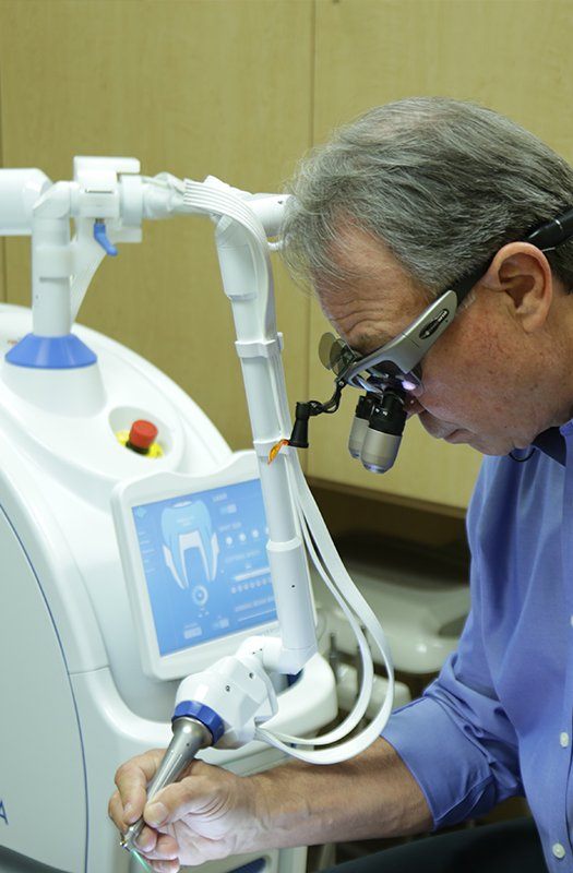 Dentist using laser technology