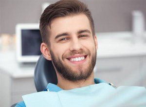 Man smiling in dentist’s chair