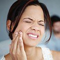 Woman holding jaw in pain