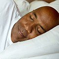 Man sleeping soundly in bed