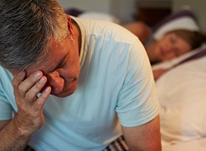 Frustrated man with head in hands