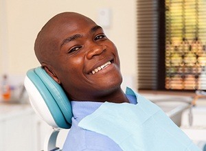 Man in dental chair with healthy smile
