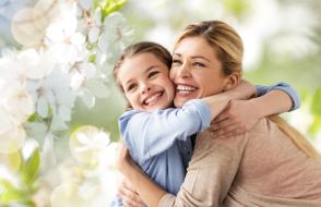 Smiling mother and daughter in the spring 